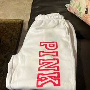 White full length sweatpants with pockets and Pink logo